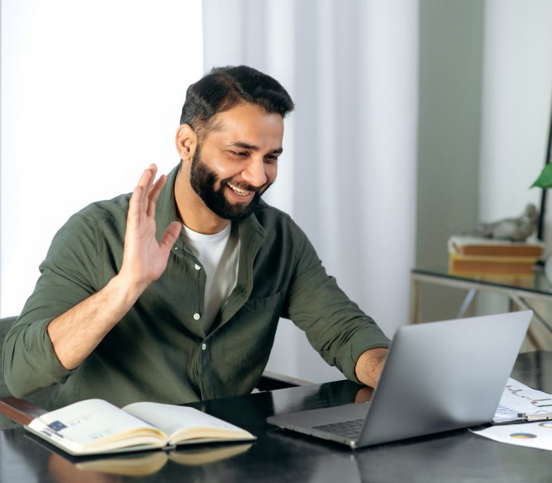 pleasant-friendly-indian-guy-manager-or-financial-consultant-communicates-with-colleagues-on-a.jpg